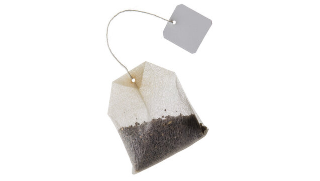 Paper tea bag with string and tag containing dark tea leaves, isolated on transparent background