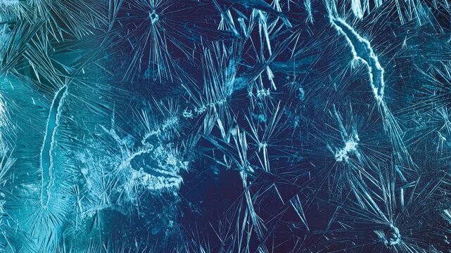 Macro timelapse of ice crystal growth freezing on glass surface with blue light.