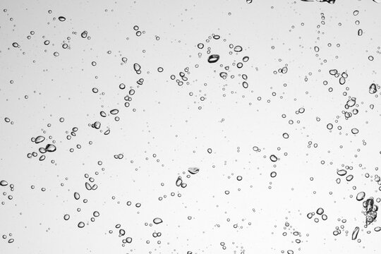 Air bubbles under water rising forming an abstract pattern
