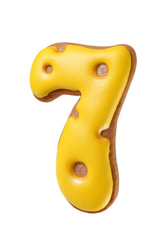 Gingerbread cookie shaped as a number seven with bright yellow icing isolated. Transparent PNG image.