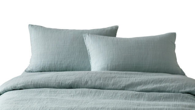 Soft textured light blue linen bedding with two pillows, isolated on transparent background