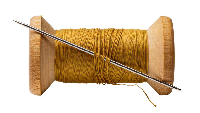 Wooden spool with golden thread and sewing needle