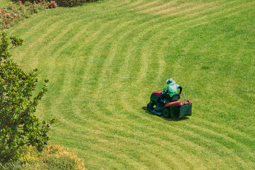 Fototapeta premium Example photo of a lawnmower in operation during landscaping and gardening work.