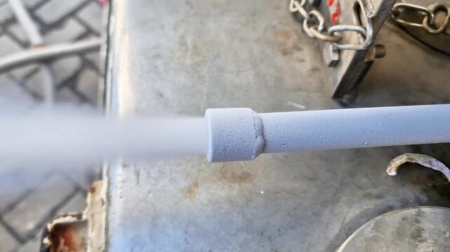 Close up of an industrial venturi nozzle spraying high-pressure steam in a manufacturing plant