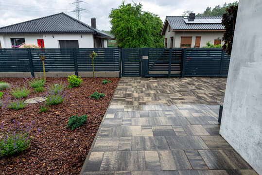 Heavy rain falling on modern driveway paving