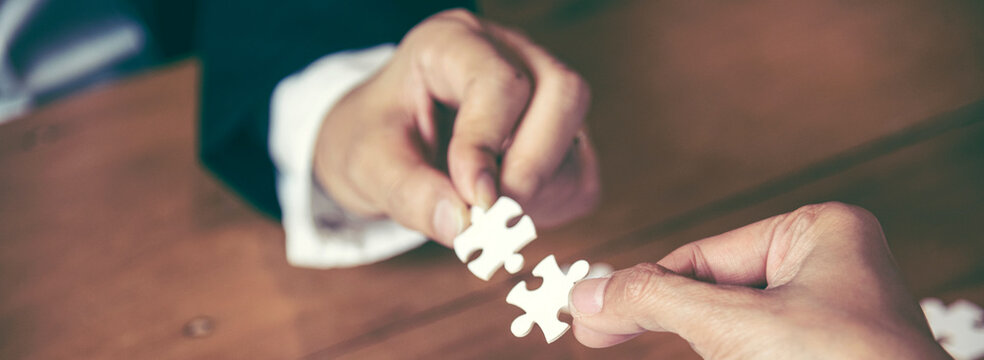 Banner Implement puzzle improve communication solve synergy team connection plan trust strategy. Piece of jigsaw assembly with copy space. Banner Business connections strategy synergy team solution