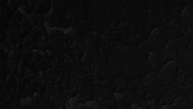 High contrast black volcanic rock texture background. Moody deep black textured concrete backdrop. 