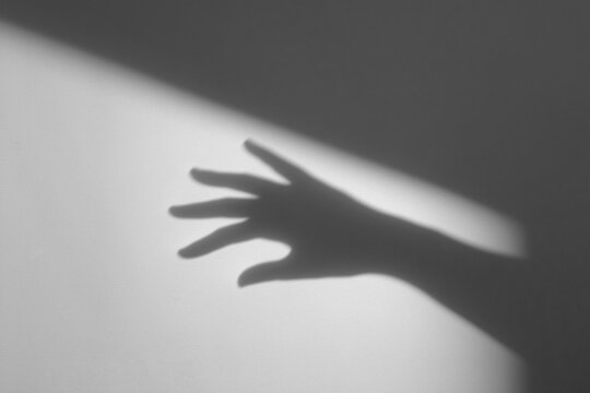 hand shadow on wall background,hand with shadow,hands shadow overlay effects,silhouette of hands,halloween background with Terrifying scary hands