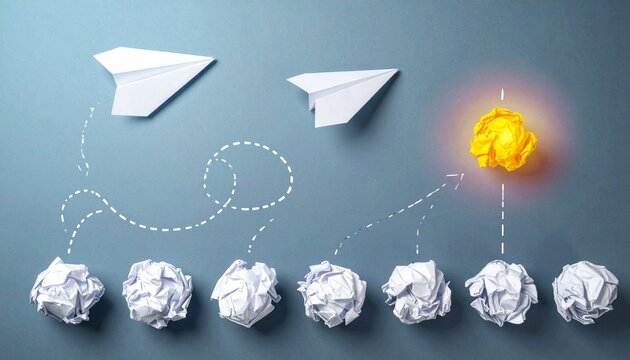 Paper airplanes crumpled balls standout yellow idea creativity concept