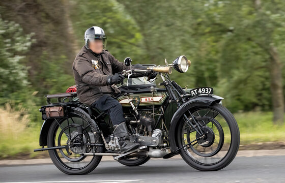 Stony Stratford,Bucks,UK - June 7th 2026:  Man riding a  classic  1921 Thompson BSA vintage motorcycle with sidecar driving on a British road