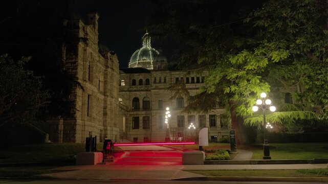 Victoria, BC, Canada &ndash; June 14, 2026: Horse carriage passing parliament at night