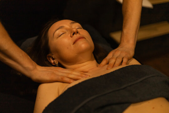 Chest and collarbone massage therapy on relaxed woman in spa clinic