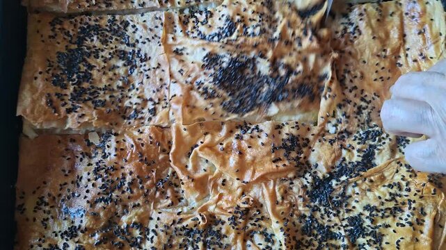 Slicing Freshly Baked Traditional Turkish Cheese Borek