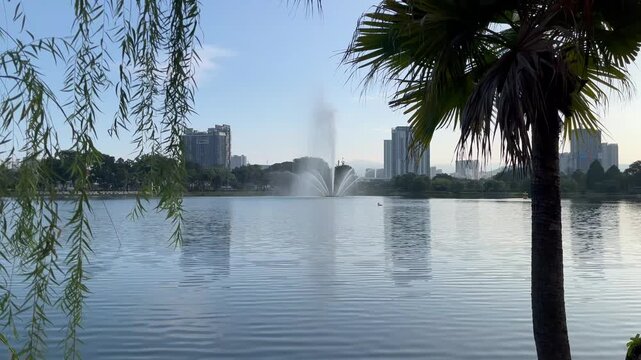 Beautiful high jet water fountain spraying at Taman Tasik Titiwangsa lake in the bright morning, Kuala Lumpur, Malaysia.