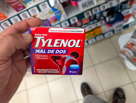 Quebec, Canada, 13 June 2026 : A person holds a box of Tylenol Extra Strength Back Pain medication in a store aisle.