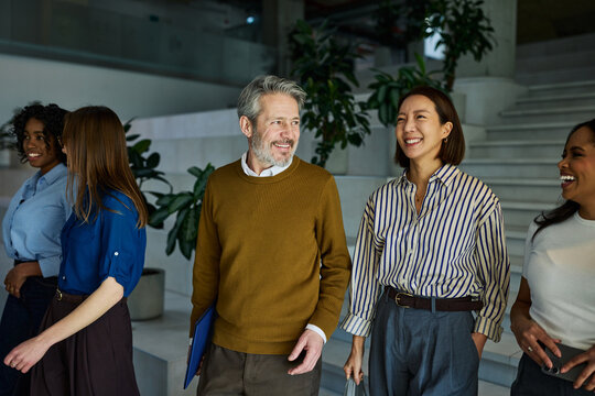 Diverse business team walking smiling in office building
