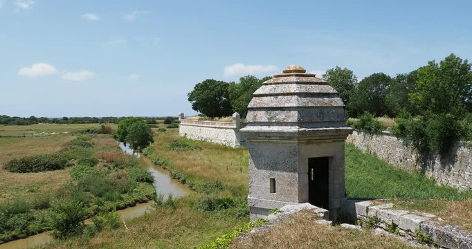 The ramparts of the Citadel of Brouage in Charente Maritime, punctuated by turrets or watchtowers facing the marshy lands,  wet meadows, salt marshes and lagoons offering a rich fauna and flora
