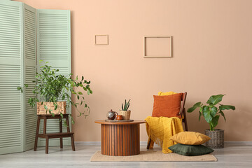 Cozy living room interior with wooden furniture, green plants, and warm textiles for home decor and comfort © Pixel-Shot