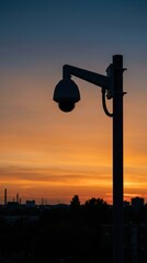 Obraz premium Surveillance camera mounted on city lamp post. Security system for public safety monitoring. Digital outdoor observation technology at sunset in urban environment. Industrial city tracking.