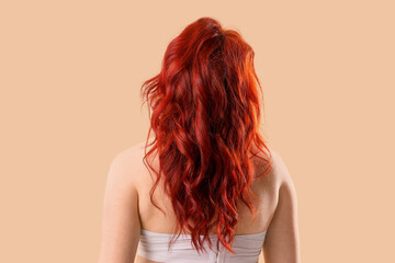 Obraz premium Woman with long wavy red hair from behind, hair care and beauty industry concept, natural hair texture