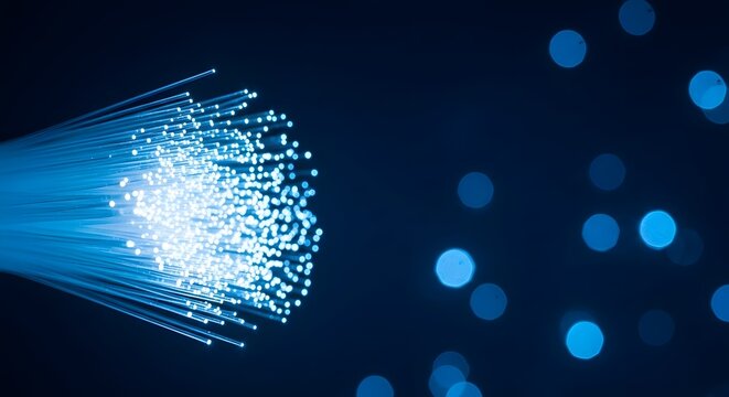 Fiber optic cables transmitting data with bokeh lights high speed internet technology concept