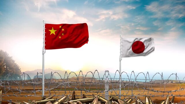 Chinese and Japanese national flags waving above a barbed wire fence