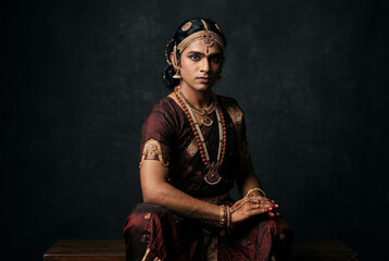 Fototapeta premium Indian Man in Traditional Saree and Temple Jewelry Studio Portrait