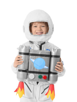 Smiling young boy in astronaut costume with handmade jetpack, space exploration and childhood imagination
