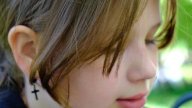 The girl&rsquo;s face is caught mid‑motion. Unposed moment. Motion blur wraps the image in a sense of immediacy, It lends the scene a distinct cinematic quality, like a frame from a film, passing moment.