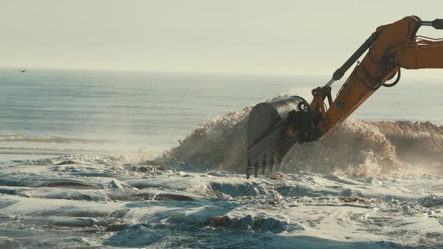 Excavator bucket working on beach nourishment project