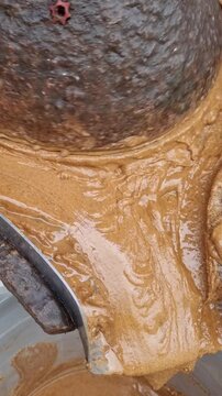 A traditional stone mill crushes and kneads the mixture of almonds, honey and argan oil to make amlu, or amlou, a spreadable cream typical of Moroccan cuisine create with authentic artisanal technique
