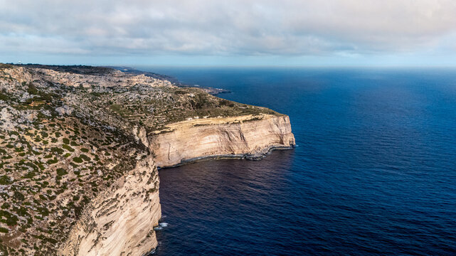 wide angle high drone view of dingli cliffs, malta with Mediterranean Sea below at summer sunset on overcast day