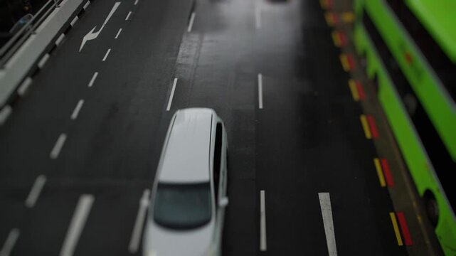 Miniature toy cars driving on a highway road