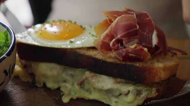 Delicious croque madame sandwich with prosciutto and fried egg