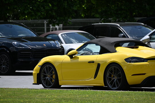 Wroclaw, Poland - June 12th 2026 - Picture of Yellow Porsche Spyder Parked with Other Porsche Cars in Parking Lot