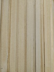 Fototapeta premium Light wooden plank texture with vertical grooves and natural grain pattern