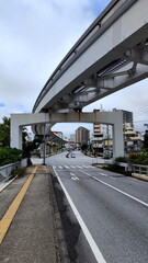 Obraz premium Street under Overpass with City on Back