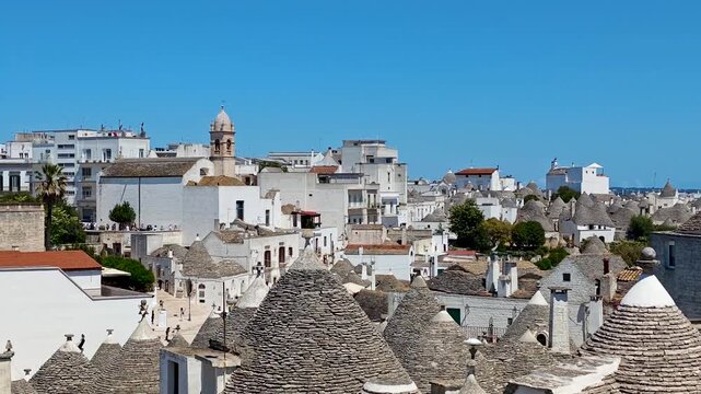 Aerial view of Alberobello traditional white trulli houses, charming Puglia village architecture and UNESCO heritage atmosphere in Italy. 4K video footage