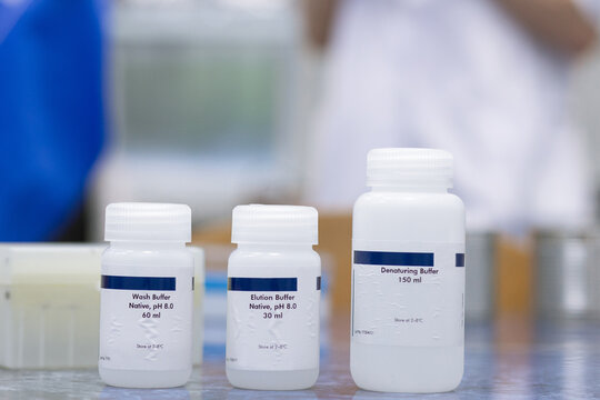 A set of chemical reagents in plastic bottles on a shelf in a laboratory. Reagents for laboratory tests.