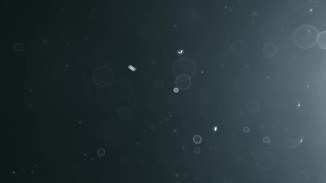 Abstract background with floating particles and dust moving dynamically in air, creating beautiful bokeh light effects.