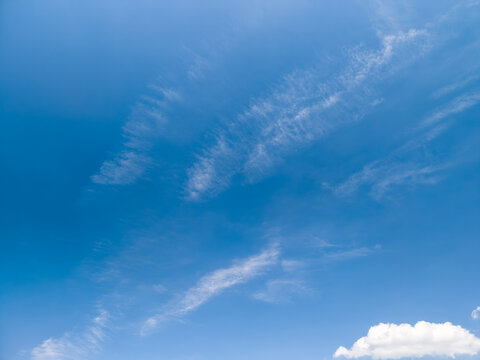 Blue sky creating expansive background with wispy clouds