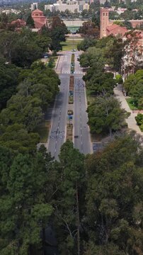 University of California, Los Angeles campus aerial pull up over Westwood Plaza revealing Janss Steps and surrounding college buildings