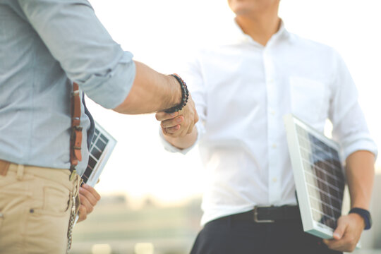 Electrical Engineer Technician and business people making handshake after meeting. clean and green alternative energy concept.