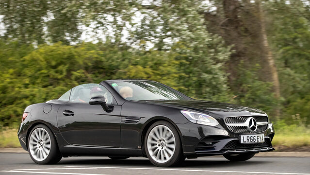 Stony Stratford,Bucks,UK - June 7th 2026:  2016 black diesel engine Mercedes Benz SLC 250 D AMG Line car driving on a British road