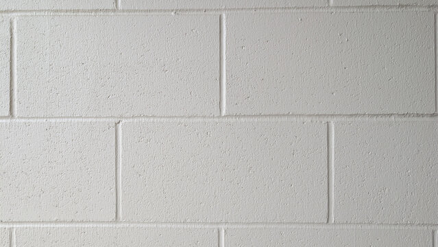 Clean white cinder block wall texture with subtle shadows and grout lines, background, texture