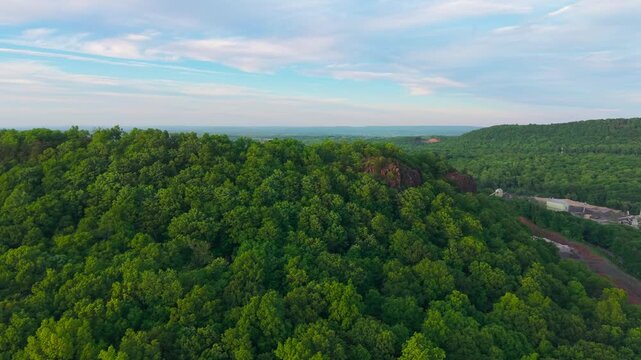Summer aerial view featuring Chauncey Peak at Doctor Francis Giuffrida Park and the Bradley Hubbard Reservoir in Meriden, Connecticut just before sunset