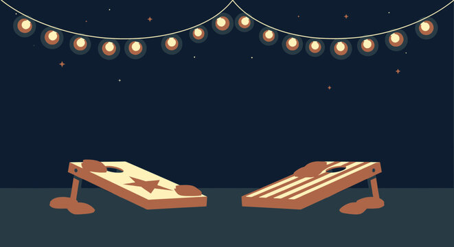 Cornhole game boards under string lights at night outdoor setup