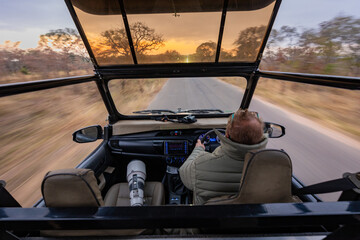 Safari game drive at sunset with open vehicle © Dewald