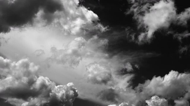 Time-lapse of white clouds moving rapidly across a black background.
Fast-moving cloud formations isolated on a dark backdrop.