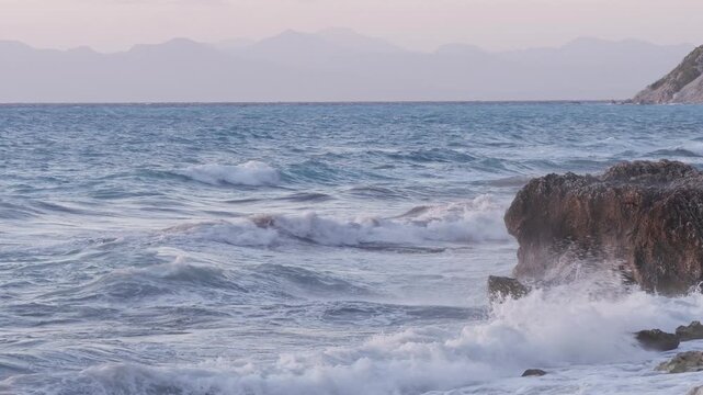Rugged Seaside Rocks Surrounded by Foamy Ocean Waves at Sunset 